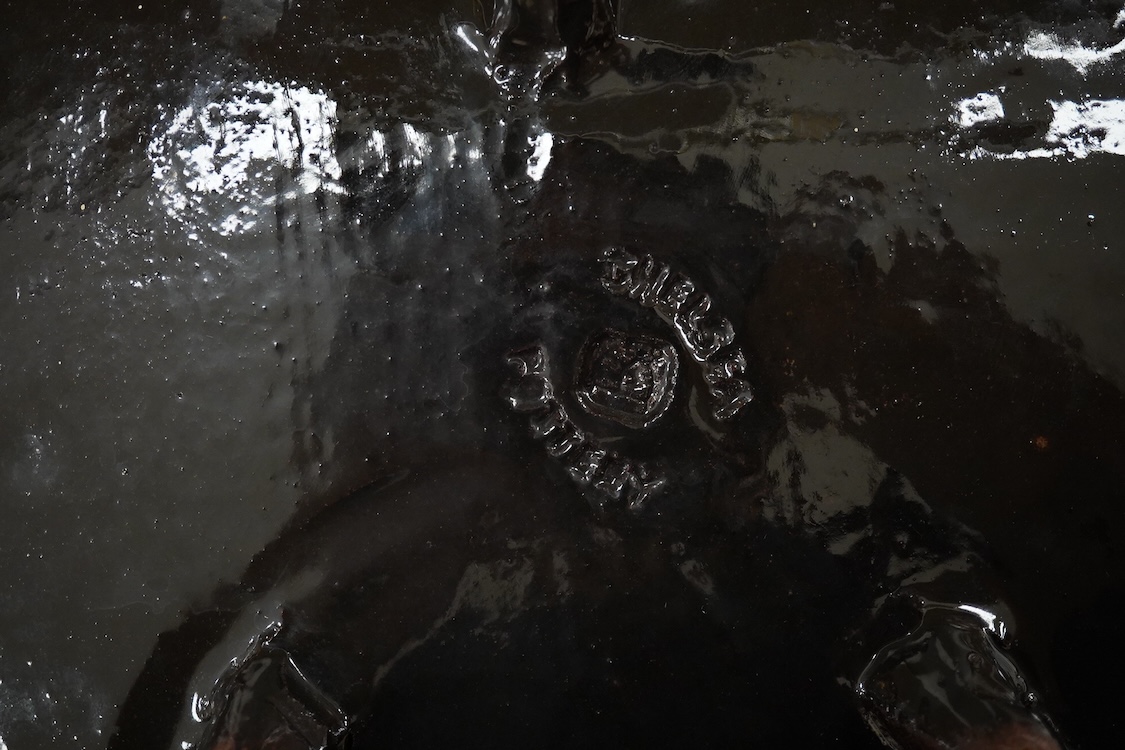 A Joyce Morgan, Chelsea pottery dish depicting a lion and lioness, monogrammed, stamped to the base, 27cm wide